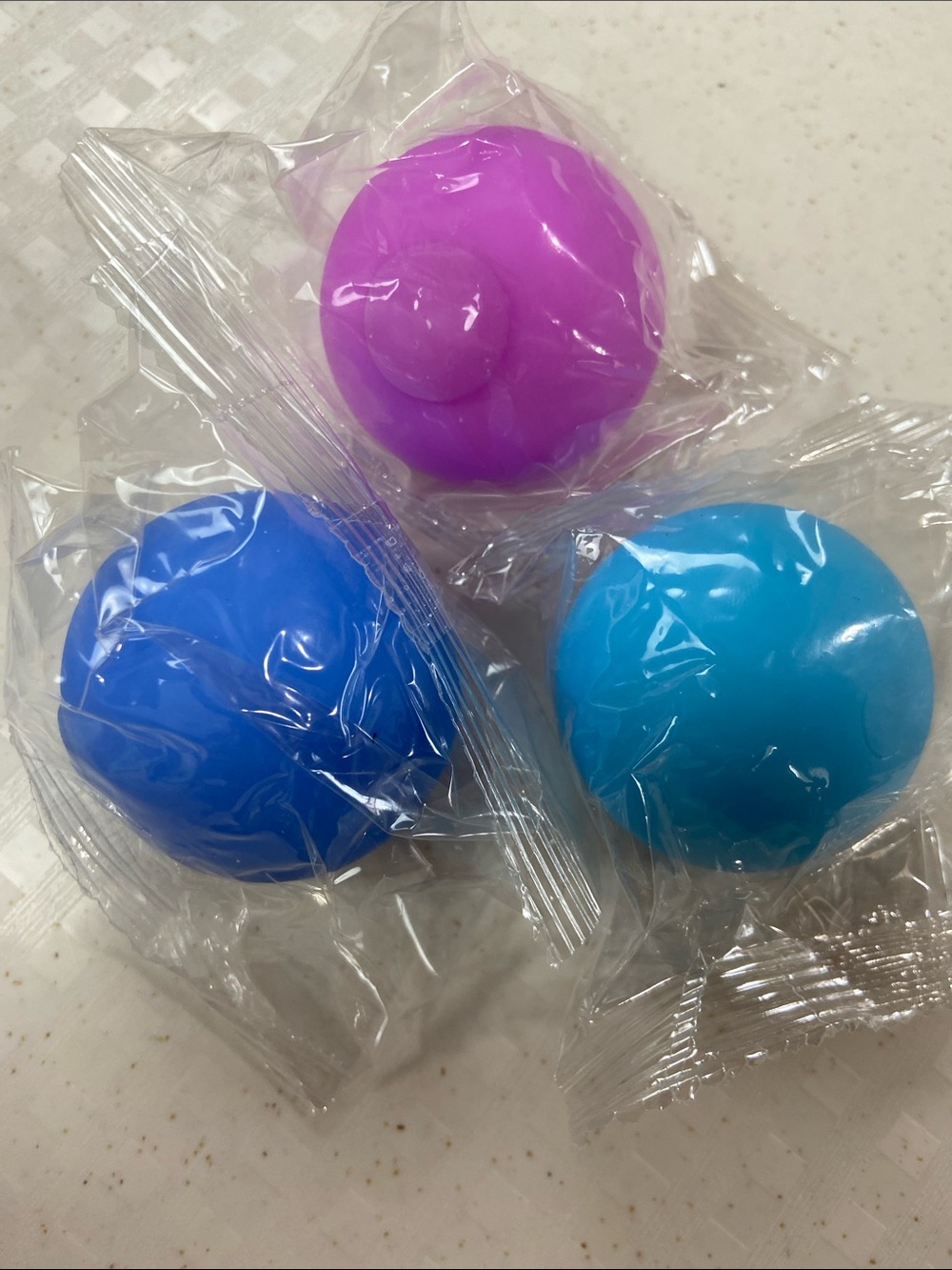 Three mini stress squishy toys